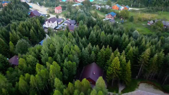 Aerial view over villas and houses in a village, in Carpathian Mountains, Ukraine - dolly, drone sho