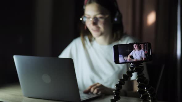 Young Blogger Girl Teenager Recording a Live Broadcast and Stream Into a Computer Game Late at Night