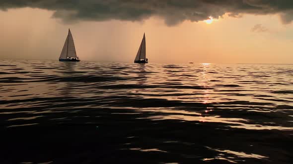 A Few Sailboats in a Sea at Sunset Magic Sun Reflection Sun Path the Sky of Pink Color the Darkness