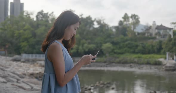 Woman Fly Drone and Stand at The Seaside