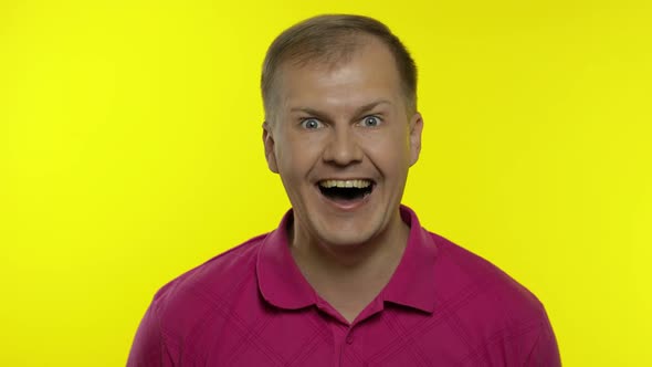 Portrait of Young Caucasian Man Posing in Pink T-shirt. Amazed Handsome Guy Shocked, Surprised