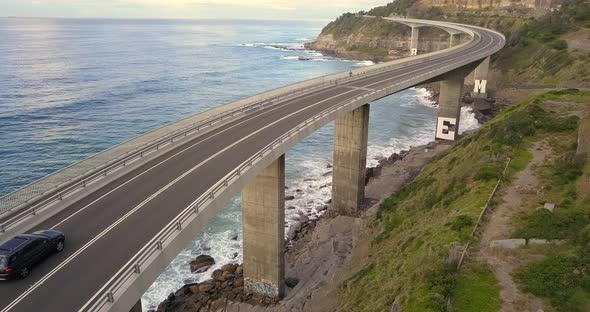 Cars Driving Along Sea Cliff Bridge