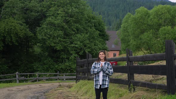 A Young Attractive Caucasian Female Stand By a Fence