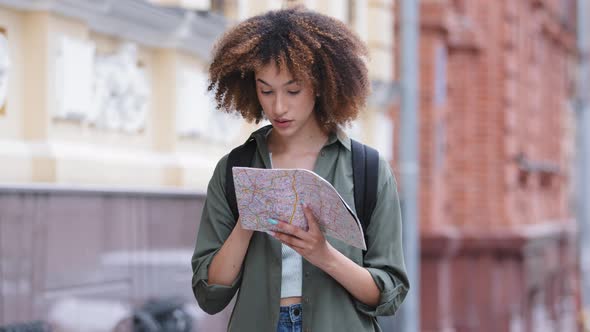 Positive Biracial Young African American Woman Hiker with Backpack Holding Travel Map
