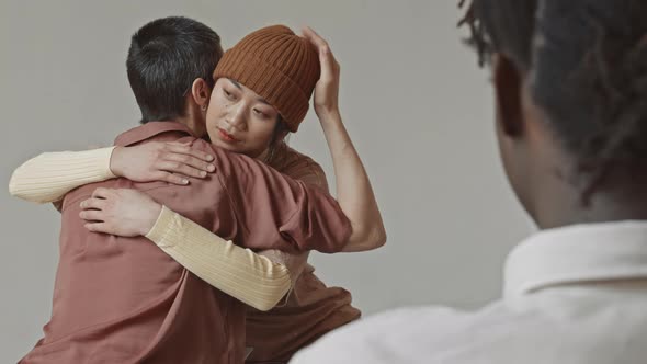 Women Hugging at Group Therapy Session