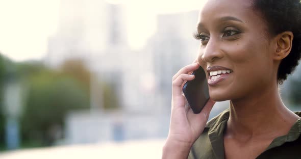 Head Shot Active Cheerful Woman Holding Smart Phone in Her Hands, Talking with Friends or Guy