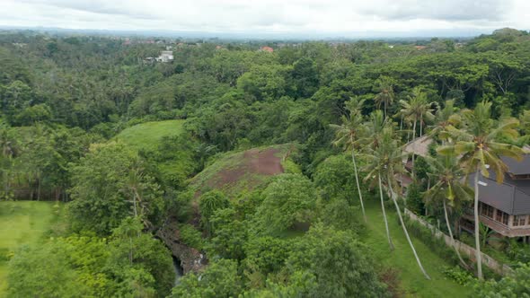 Low Flying Aerial Dolly Shot of a Luxury Resort Villas Hidden in the Dense Green Rainforests of Bali