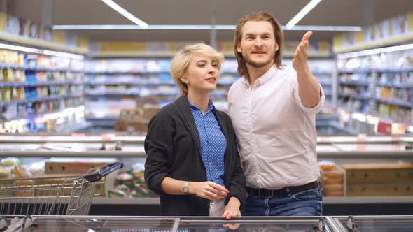 Shopping Time. Preparing To Christmas Dinner. Couple Enjoying in Shopping Mall