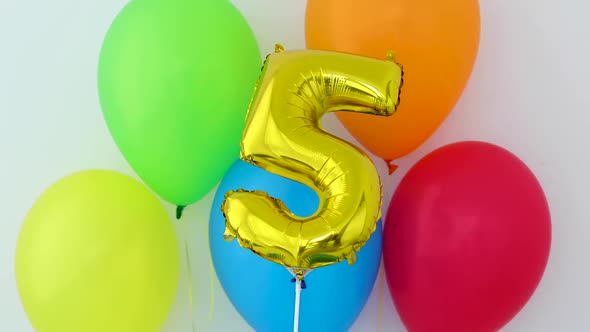 Gold Foil Number 5 Celebration Balloon on a Color