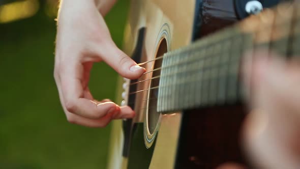 Beautiful Young Woman Playing Guitar