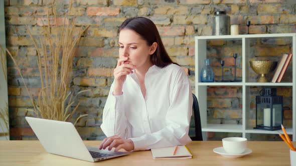 Beautiful Young Businesswoman Working on Computer at Her Working Place in Office