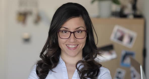 Portrait of woman at home office studio wearing a shirt and eyeglasses