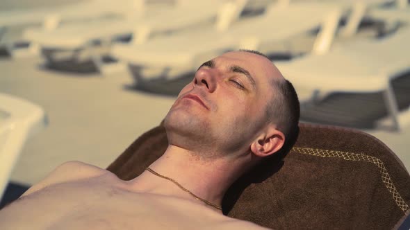 Closeup Travelling Italian Man Sunbathing on Beach Closing Eyes