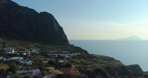 Panoramic and Picturesque Rocky Coastline During Sunset with Green Fields Trees and Small Village