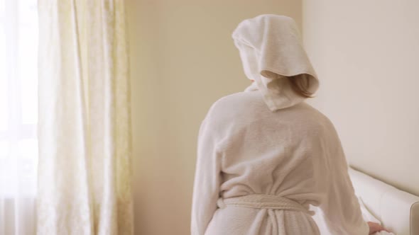 Young Woman Using Smartphone After Shower.