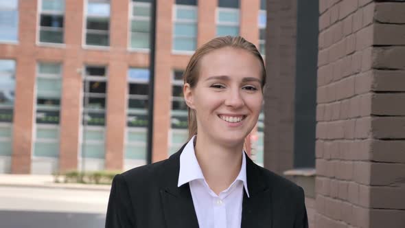 Smiling Businesswoman Walking Ouside Office