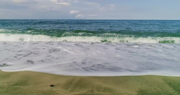 Aerial view of wavy sea and coastline landscape