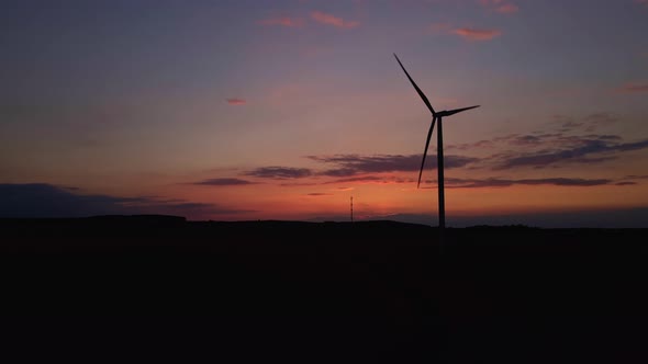 Silhouette of Windmill Turbine in Field at Sunset Sky