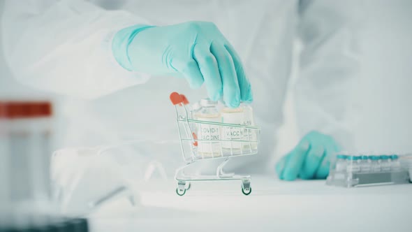 Doctor Takes a COVID19 Vaccine Vial From Small Shopping Cart