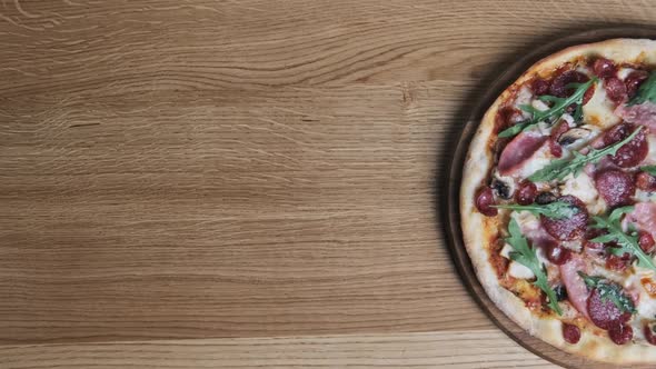 Appetizing Pizza on a Wooden Board in a Restaurant