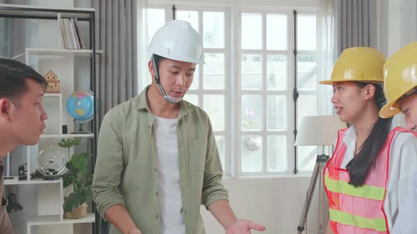 Engineers With Helmets Sharing Ideas About Work To A Man At The Office, Angry Colleagues Debate