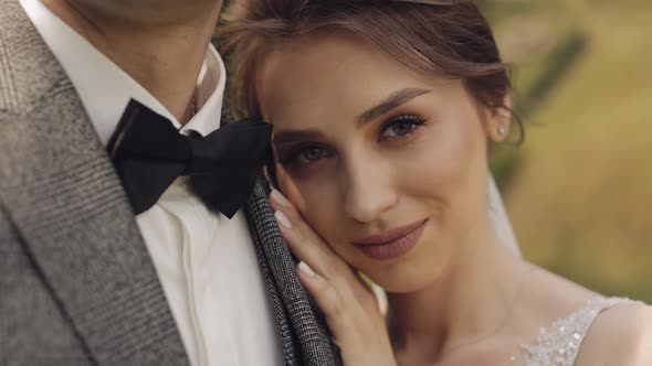 Newlyweds Bride Woman Lying on Her Husband Shoulder and Looking at Camera Happy Wedding Couple