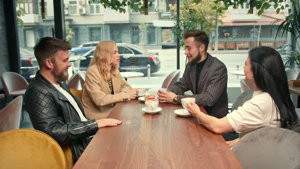 Cheerful company of friends socializing on weekend spending time together. Friendship.