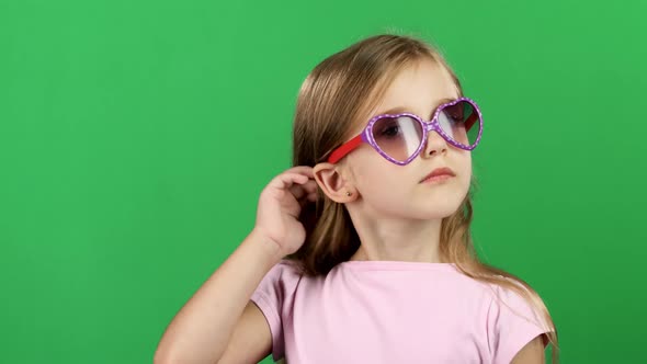 Baby Posing for Video Cameras with Glasses. Green Screen