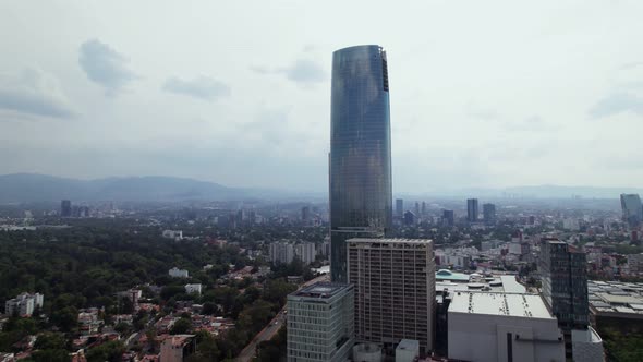 Aerial Rising View Of Centro Comercial Mítikah With Cityscape View In Background In Mexico City