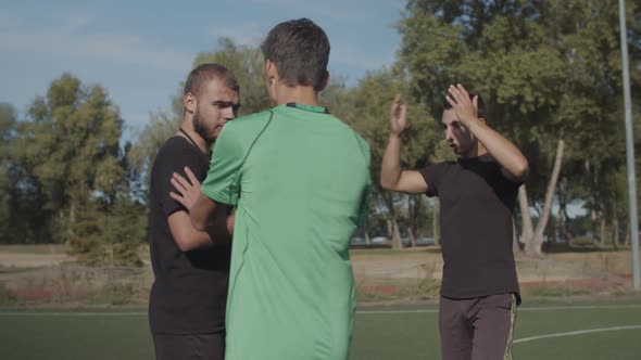 Soccer Team Arguing with Referee for Dismissal