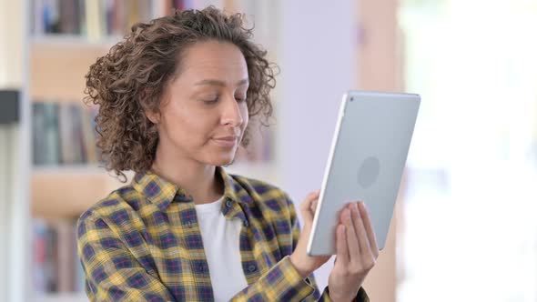 Portrait of Mixed Race Woman Celebrating on Tablet