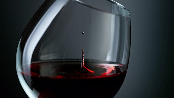 Super Slow Motion Shot of Wine Drop Falling Into Red Wine in Glass at 1000Fps