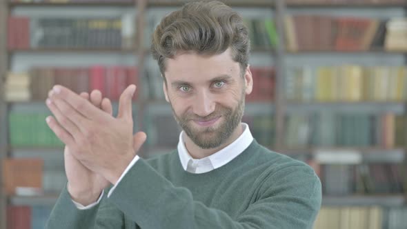 Cheerful Young Man Clapping and Celebrating