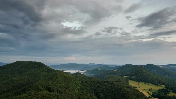 Calm Evening with Gray Clouds Moving over Green Forest Nature