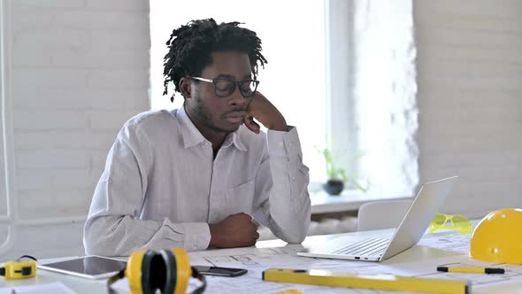 African Engineer Sleeping in Office