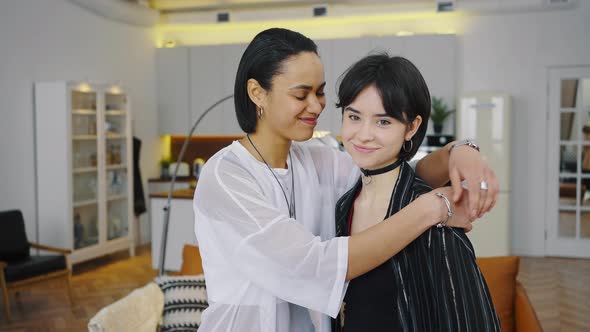 Portrait of Hugging Young Women in Home Interior