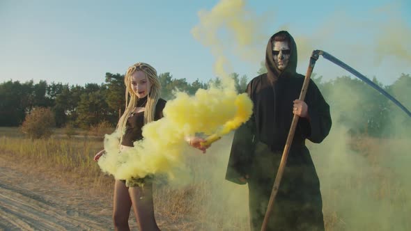 Vampire and Grim Reaper Standing in Smoke in Nature