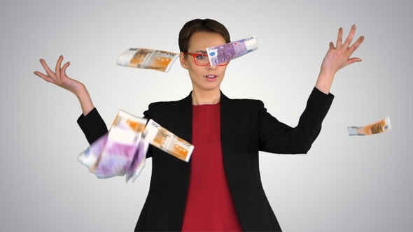 Business woman in glasses tossing money in the air on gradient