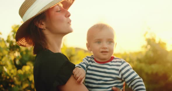 Portrait Happy Mother with Her Lovely Little Child in French Provence Vineyard During Summer Sunset