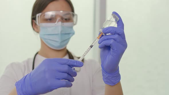 The Doctor Fills the Syringe With the Vaccine in Preparation for the Injection