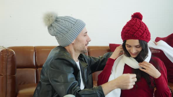 Man tucked scarf around woman neck