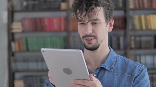 Young Casual Man Using Tablet at Workplace