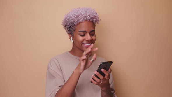 Happy African American Woman Listening to Music on Wireless Headphones