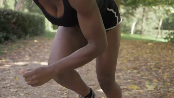 workout, concentration, stroke. Young African athlete gets ready to run