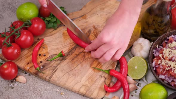 Woman Hands Slicing Chopping Chili Pepper at Domestic Kitchen