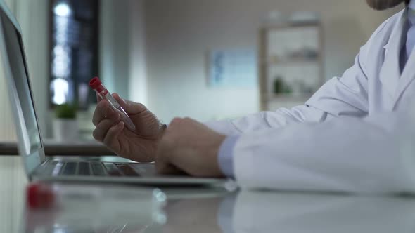 Doctor Typing Information From Test Tube, Adding Results to Medical Record, Lab