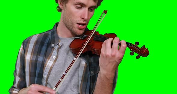 Close-up of male musician singing while playing violin