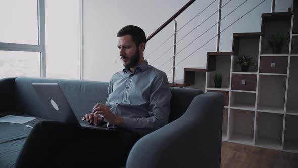 Man Using Laptop and Spending Free Time at Home