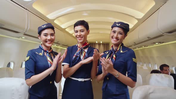 Cabin Crew Clapping Hands in Airplane