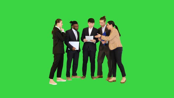 Group of Colleagues Discuss Holding Documents on a Green Screen Chroma Key